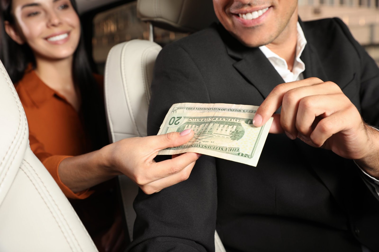 Young,Woman,Giving,Money,Taxi,Driver,In,Modern,Car,,Closeup